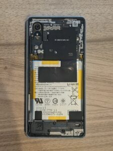 Xperia Ace IIIの背面パネルを取り外し、内部基板と古いバッテリーが露出した画像