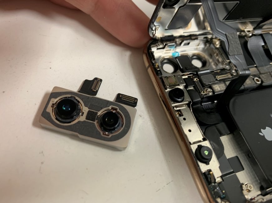 バックカメラパーツを取り出したiPhoneXS
