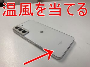 背面パネルに温風を当てて分解している画面交換修理前のGalaxy S22